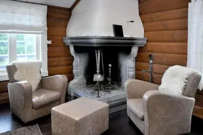 a living room with two chairs and a fireplace at Storsten 695 - Trysil in Trysil