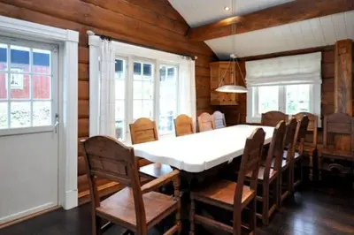 a dining room with a white table and chairs at Storsten 695 - Trysil in Trysil