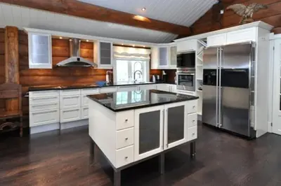 a kitchen with white cabinets and stainless steel appliances at Storsten 695 - Trysil in Trysil