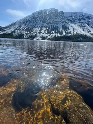 a mountain in the middle of a body of water at Hytte Elvdal in Nymoen