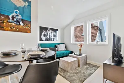 a living room with a table and a couch at Luxury Suite in Charming Area in Bergen