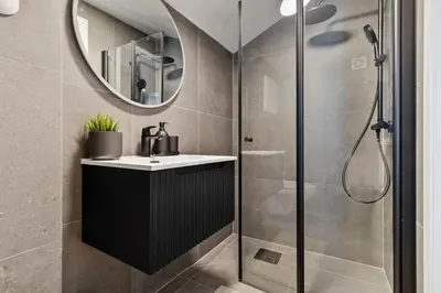 a bathroom with a sink and a shower at Luxury Suite in Charming Area in Bergen