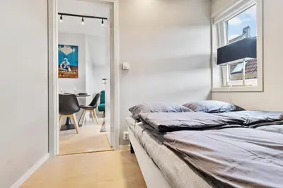 a bedroom with a bed and a mirror at Luxury Suite in Charming Area in Bergen