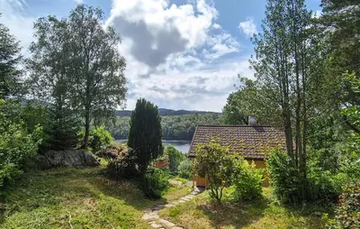 a house with a view of a river and trees at 1 Bedroom Stunning Home In Haugesund in Haugesund