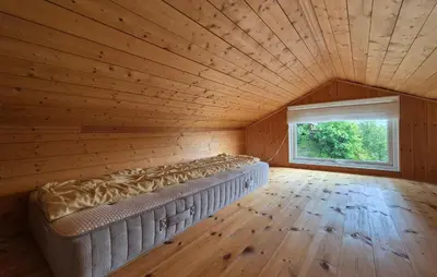 a large bed in a room with a large window at 1 Bedroom Stunning Home In Haugesund in Haugesund