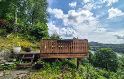 a wooden bench sitting on top of a hill at 1 Bedroom Stunning Home In Haugesund in Haugesund