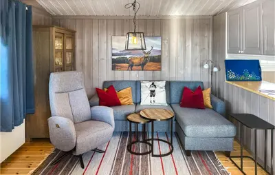 a living room with a couch and a chair at 4 Bedroom Awesome Home In Engerdal in Nymoen