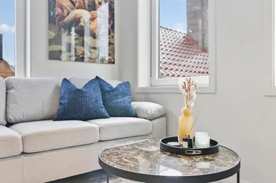 a living room with a couch and a table at Exclusive Bergen Suite in Bergen