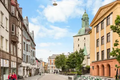 a city street with buildings and a tower at BREEZE Hotel Victoria - Self-Service in Bergen