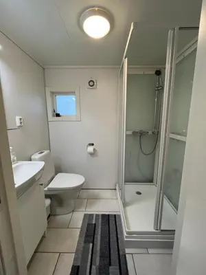 a bathroom with a shower and a toilet and a sink at Gulthus in Odda