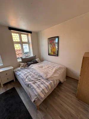 a bedroom with a bed with a laptop on it at Spacious and central apartment I 250m from Bryggen in Bergen