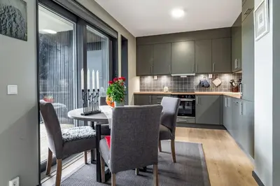 a kitchen and dining room with a table and chairs at Mountain appartment in Sjusjøen
