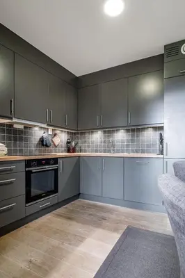a kitchen with gray cabinets and a counter at Mountain appartment in Sjusjøen