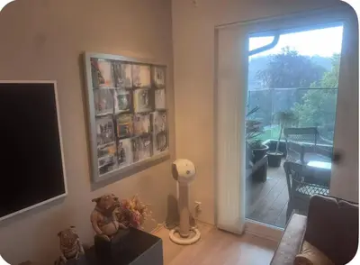 a living room with a television and a sliding glass door at Moderne Leilighet in Stord