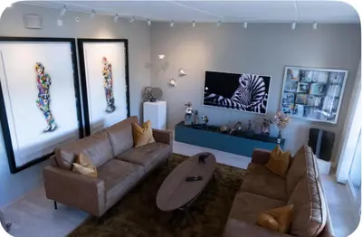 a living room with a couch and a table at Moderne Leilighet in Stord