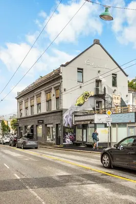 a building with a mural on the side of it on a street at BUDGETEL- Kong Oscarsgate 44 in Bergen