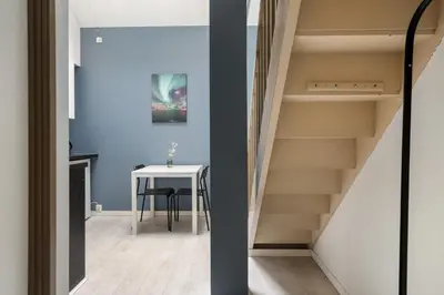 a staircase leading up to a room with a table at BUDGETEL- Kong Oscarsgate 44 in Bergen