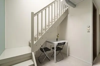 a staircase with a table and a chair next to it at BUDGETEL- Kong Oscarsgate 44 in Bergen