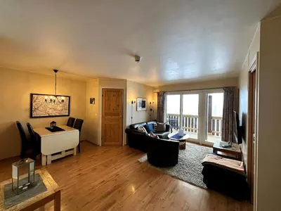a living room with a couch and a desk at Family-Friendly Apartment Steps From Everything in Beitostøl