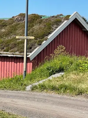 a street sign in front of a red building at Atlantic Dome in Skotten