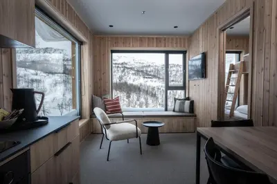 a kitchen with a window and a table and chairs at Filefjellstuene Hotel in Tyinkrysset