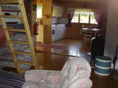 a living room with a bunk bed and a kitchen at Hytte på fjellet, med mange turmuligheter ! in Gol