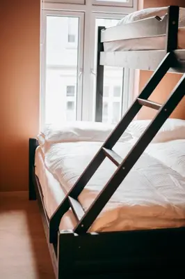 two bunk beds in a room with a window at Bergen City Apartment in Bergen