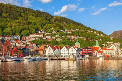 a town on the shore of a body of water with boats at Bergen City Apartment in Bergen