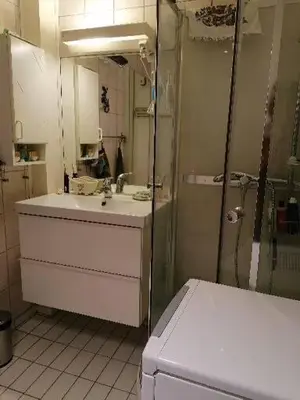 a bathroom with a sink and a shower at Leilighet nær Trondheim in Trondheim