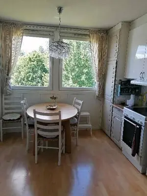 a kitchen with a table and chairs in a room at Leilighet nær Trondheim in Trondheim