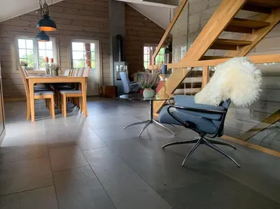 a living room with a table and a chair at Spacious Mountain Lodge Stryn in Stryn