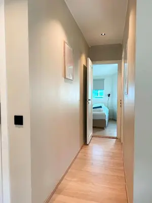 a hallway with a door leading to a bedroom at Celestial Bergen Central Apartment in Bergen