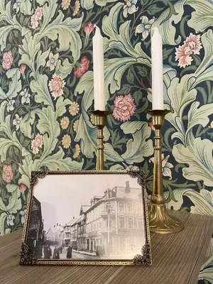 a picture of a house with two candles on a table at Jugend 1902 in Ålesund
