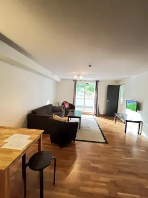 a living room with a couch and a table at Voss-Oppheim Resort appartment witc acess to swimmingpool in Øyjordi
