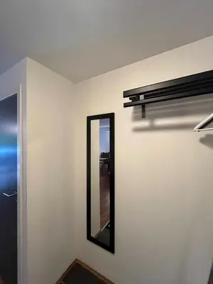 a mirror on a wall next to a door at Voss-Oppheim Resort appartment witc acess to swimmingpool in Øyjordi