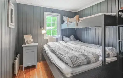 a bedroom with a bunk bed and a window at Koselig Fjellhytte Med Utsikt in Bykle