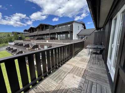 a balcony with a view of a building at Small Family Retreat Two Bedrooms And Easy Access in Beitostøl