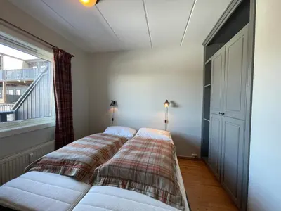 a bedroom with a bed with a plaid blanket at Small Family Retreat Two Bedrooms And Easy Access in Beitostøl