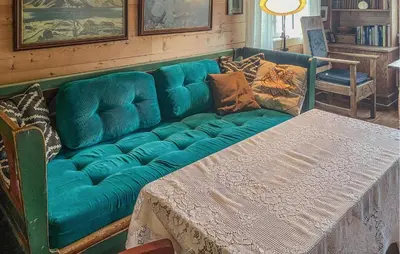 a blue couch with pillows on it in a room at Beautiful Home In Vassenden in Vassenden
