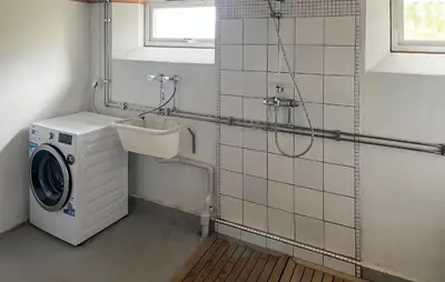 a washing machine in a bathroom with a washer at Beautiful Home In Vassenden in Vassenden