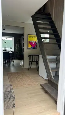 a living room with a staircase in a house at Skarnsundet apartment in Venneshamn