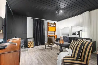 a living room with a couch and a table at Skarnsundet apartment in Venneshamn