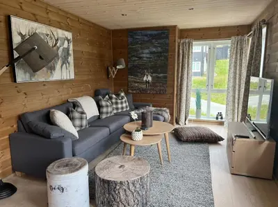 a living room with a couch and a table at ChaletMons, stor trivelig leilighet i Myrkdalen in Vossestrand