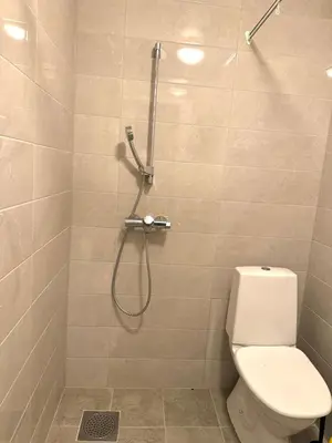 a bathroom with a shower with a toilet at BUDGETEL- Kong Oscarsgate 48 in Bergen