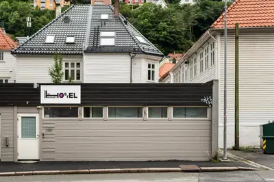a building with a garage door in a city at BUDGETEL- Kong Oscarsgate 48 in Bergen