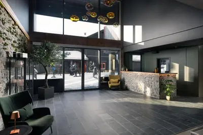 a lobby of a building with a couch and chairs at Riddergaarden Hotel & Mountain Lodge, Beitostølen in Beitostøl