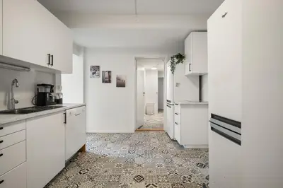 a kitchen with white cabinets and a tile floor at One of a kind in Bergen I 7 Bedrooms I 15 Guests! in Bergen