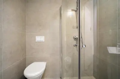a bathroom with a shower with a toilet and a sink at One of a kind in Bergen I 7 Bedrooms I 15 Guests! in Bergen