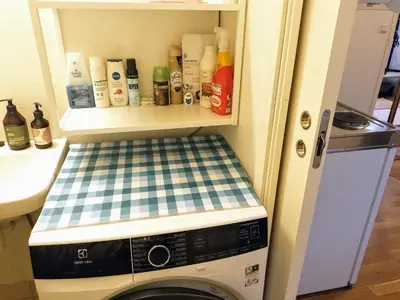 a washer and dryer in a kitchen with a counter at Cosy apartment near city center in Bergen