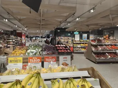 a grocery store with bananas and other fruits and vegetables at Cosy apartment near city center in Bergen